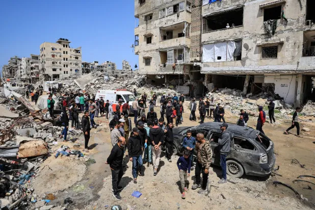 Palestinians inspect the damage after a person was hit by an Israeli strike while riding a bicycle, according to medics, in Gaza City, April 6, 2026. REUTERS/Dawoud Abu Alkas