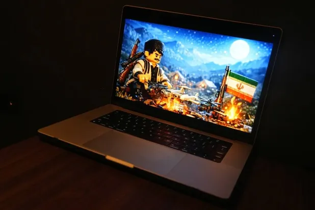 An AI-generated animation created by a pro-Iran studio and depicting ​​​an Iranian man grilling four US aircraft like a kebab over a campfire is seen on a computer screen in Brussels, Wednesday, April 8, 2026. (AP)