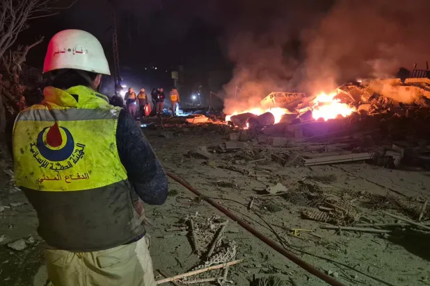 First responders gather at the site of an Israeli airstrike in the village of Habbouch, southern Lebanon on April 10, 2026. (Photo by Abbas FAKIH / AFP)