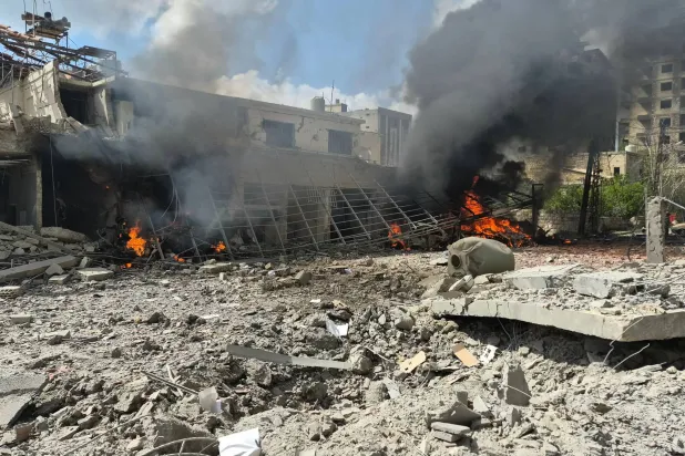 Flames and smoke engulf part of the site of an Israeli airstrike that targeted the Lebanese State Security Center, in the Southern Lebanese city of Nabatieh on April 10 2026. (AFP)