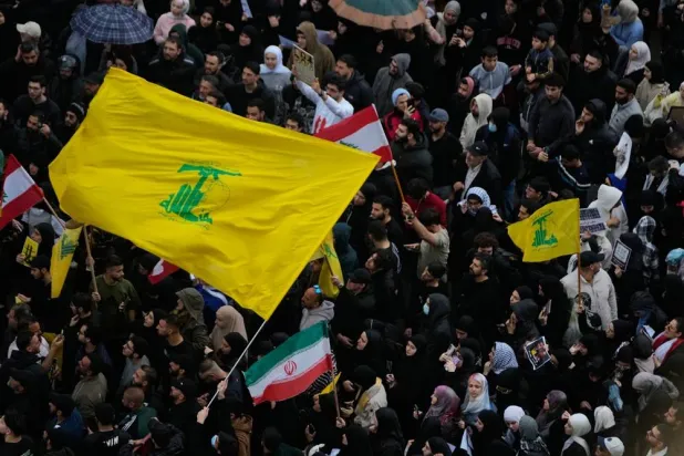  Protesters wave Hezbollah and Iran's flags during a protest against the Lebanese Prime Minister Nawaf Salam, in front the government palace in Beirut, Lebanon, Friday, April 10, 2026. (AP) 