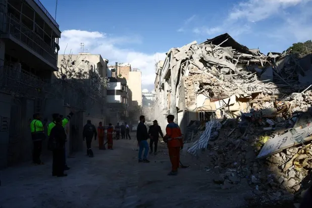  People stand next to a Synagogue, which was damaged in a strike, amid the US-Israeli conflict with Iran, in Tehran, Iran, April 7, 2026. Majid Asgaripour/WANA (West Asia News Agency) via Reuters
