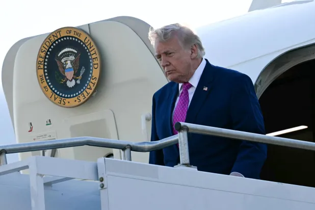 ترمب يترجل من طائرة الرئاسة في مطار شارلوتسفيل-ألبيمارل، بولاية فرجينيا (أ.ف.ب)