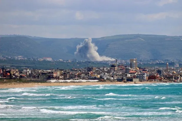 This photograph taken from the southern Lebanese area of Tyre shows smoke rising from the site of an Israeli strike that targeted the southern village of Qlaileh on April 11, 2026. (AFP)