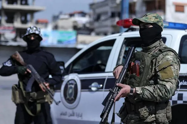 This handout picture released by the official Syrian Arab News Agency (SANA) on March 8, 2025, shows Syrian forces manning a checkpoint in the coastal city of Latakia. (SANA/AFP) 