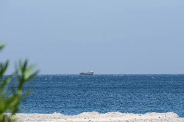 A boat is off the coast of Musandam governorate, overlooking the strait of Hormuz, in Musandam governance, in Oman, April 8, 2026. (Reuters)