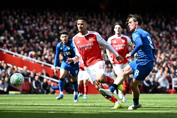 تسديدة أليكس سكوت في طريقها لمعانقة شباك آرسنال وتحقيق الفوز لبورنموث (رويترز)