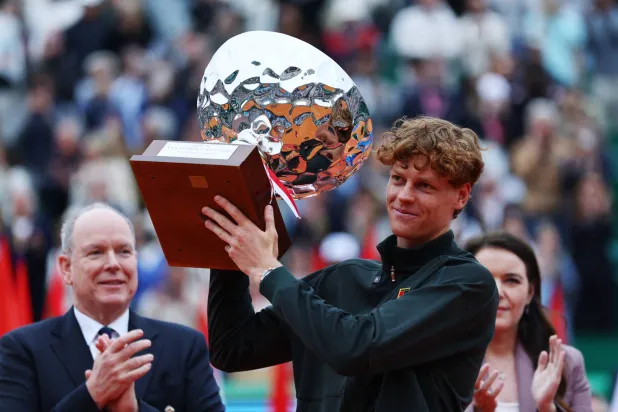 Tennis - ATP Masters 1000 - Monte Carlo Masters - Monte Carlo Country Club, Roquebrune-Cap-Martin, France - April 12, 2026 Italy's Jannik Sinner celebrates with the trophy after winning his final match against Spain's Carlos Alcaraz REUTERS/Manon Cruz