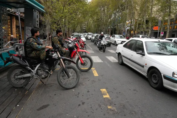 Policemen sit on their motorcycles in northern Tehran, Iran, Sunday, April 12, 2026. (AP Photo/Vahid Salemi)