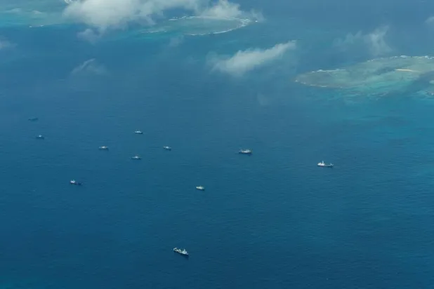 An aerial view of what Philippine Coast Guard alleges were Chinese vessels, manned by Chinese maritime militia loitering within the vicinity of Thitu Island, one of nine features occupied by the Philippines in Spratly Islands, in the disputed South China Sea, March 9, 2023. (Reuters)
