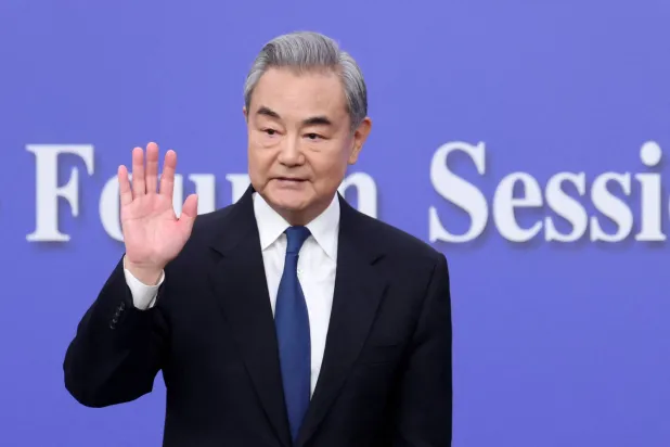 Chinese Foreign Minister Wang Yi waves after a press conference on the sidelines of the National People's Congress (NPC), in Beijing, China, March 8, 2026. (Reuters)