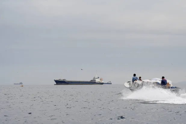 Ships and a boat in the Strait of Hormuz on April 12, 2026 (Reuters)