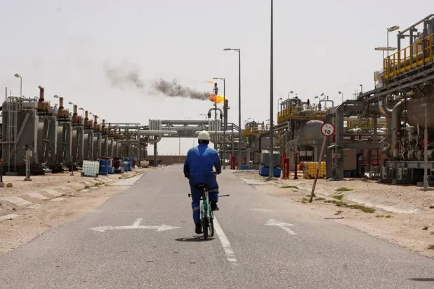 A worker rides a bicycle at the Zubair oil field in Basra, Iraq, April 6, 2026. (Reuters)