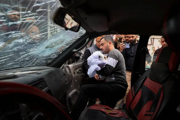 A father holds the body of his three‑year‑old child, Yahya Al‑Malahi, who was killed in an Israeli strike, according to medics, during his funeral in Gaza City, April 14, 2026. (Reuters)