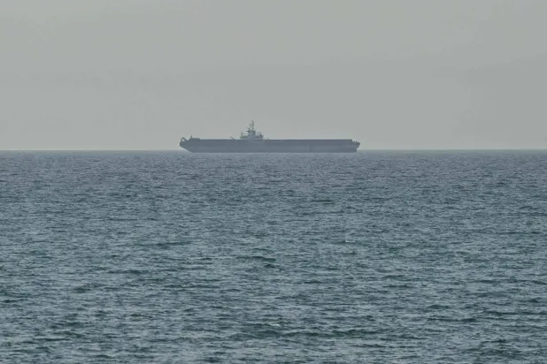 A ship is seen off the coast of Ras al-Khaimah, the day after the failure of US-Iran peace talks on April 13, 2026. (AFP)