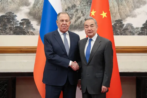 In this handout picture provided by the Russian Foreign Ministry on April 14, 2026, Russian Foreign Minister Sergei Lavrov and Chinese Foreign Minister Wang Yi shake hands during a meeting in Beijing. (Handout / Russian Foreign Ministry / AFP) 