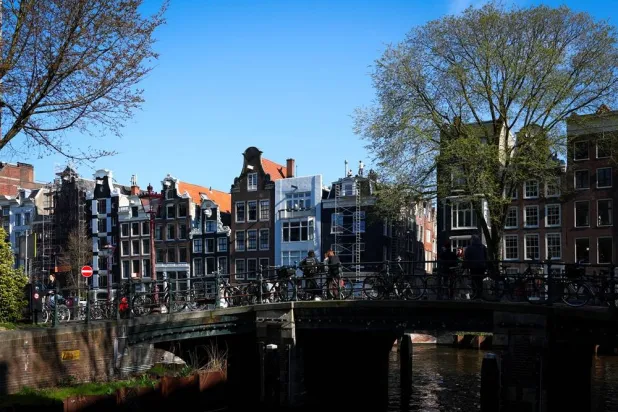 Typical Amsterdam houses sit next to a canal in Amsterdam, Netherlands, March 19, 2026. (Reuters) 