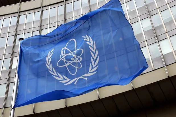01 November 2004, Austria, Vienna: The flag of the International Atomic Energy Agency (IAEA) flies in front of the UN seat in Vienna. (dpa)