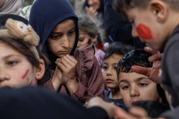 Displaced children queue to get toys at a shelter in Tyre, south Lebanon, April 14, 2026. (Reuters)