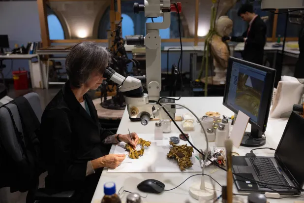 A conservator works on the restoration of gilded moldings at the Prado museum's sculpture restoration department in Madrid on October 23, 2025. (Pierre-Philippe Marcou/ AFP) 