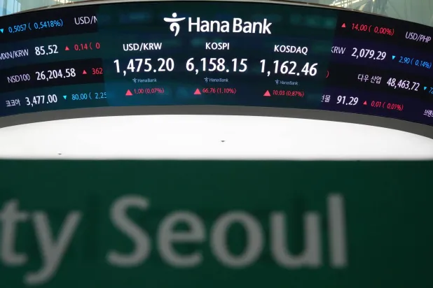 The screens showing the Korea Composite Stock Price Index (KOSPI), the foreign exchange rate between US dollar and South Korean won and the Korean Securities Dealers Automated Quotations (KOSDAQ) at a dealing room of Hana Bank, in Seoul, South Korea, Thursday, April 16, 2026. (AP Photo/Lee Jin-man)