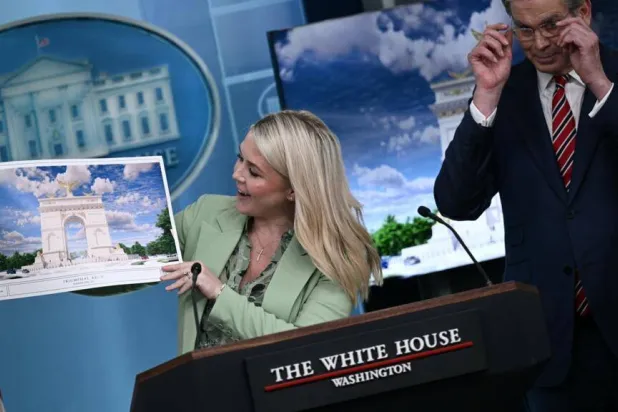 White House Press Secretary Karoline Leavitt shows off an artist's rendering of President Donald Trump's planned Triumphal Arch. Brendan SMIALOWSKI / AFP
