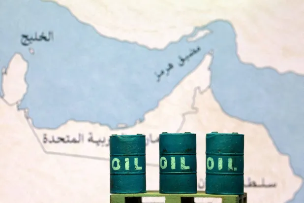 FILE PHOTO: A map showing the Strait of Hormuz, also known as Madiq Hurmuz, and 3D printed oil barrels are seen in this illustration taken March 26, 2026. REUTERS/Dado Ruvic/Illustration//File Photo