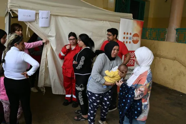 Mariam Zein (R) brings her son to a mobile health clinic run by charity Caritas Lebanon. Joseph EID / AFP
