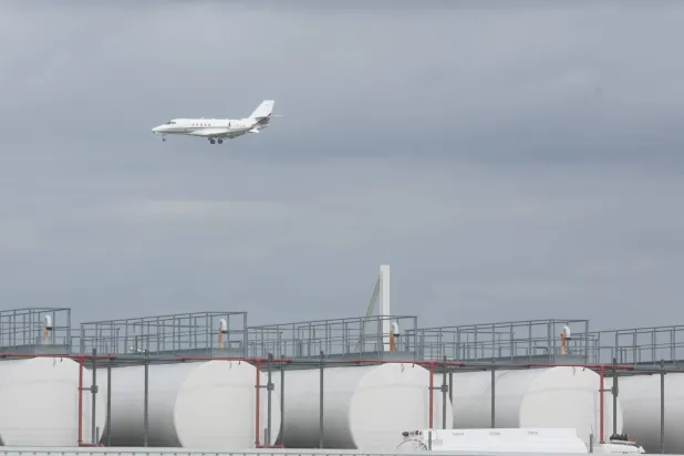  Aircraft pass behind kerosene storage facilities at Liege Airport in Liege, Belgium, 16 April 2026.  EPA/Olivier Hoslet