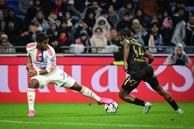 Lyon's Brazilian forward #09 Endrick (L) fights for the ball with Lorient's Cameroonian defender #44 Darlin Yongwa (R) during the French L1 football match between Olympique Lyonnais (OL) and FC Lorient at the Groupama Stadium in Decines-Charpieu, central-eastern France, on April 12, 2026. (Photo by OLIVIER CHASSIGNOLE / AFP)