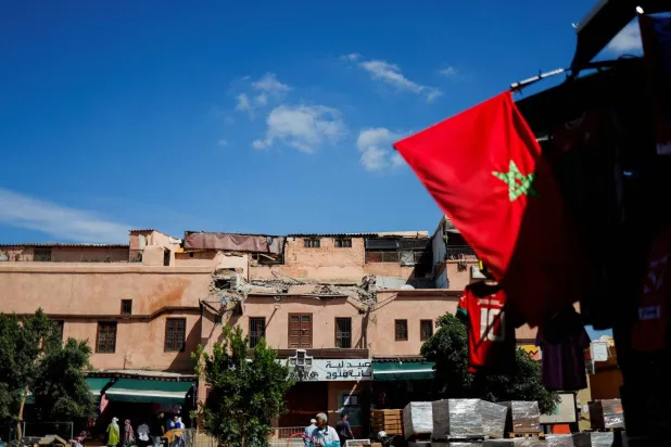 The Moroccan flag is seen in front of a destroyed building following the devastating earthquake in Marrakesh last month. (Reuters) 