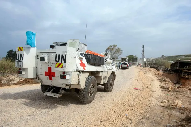 A United Nations Interim Force in Lebanon (UNIFIL) ambulance crosses the Qasmiyeh bridge heading toward Sidon and Beirut. (AFP)