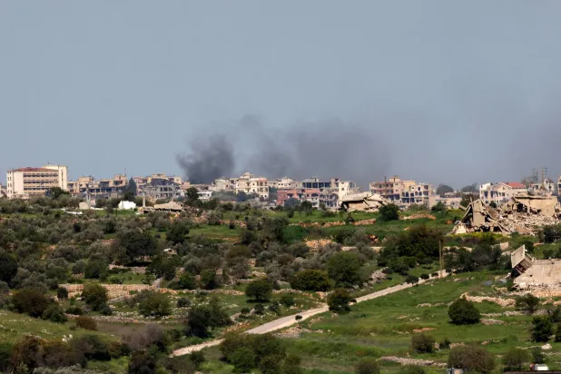 Smoke rises over the southern Lebanese village of Bint Jbeil near the border as seen from the Upper Galilee in northern Israel, on April 17, 2026. (AFP)