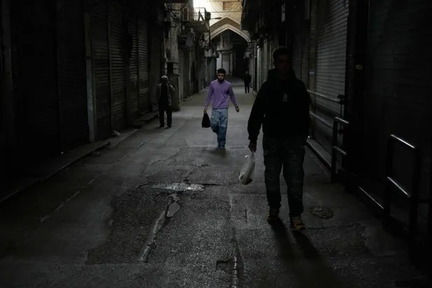 People walk past closed shops at the nearly empty traditional main bazaar during Iranian New Year, or Nowruz, holidays in Tehran, Iran, Sunday, March 29, 2026. (AP)