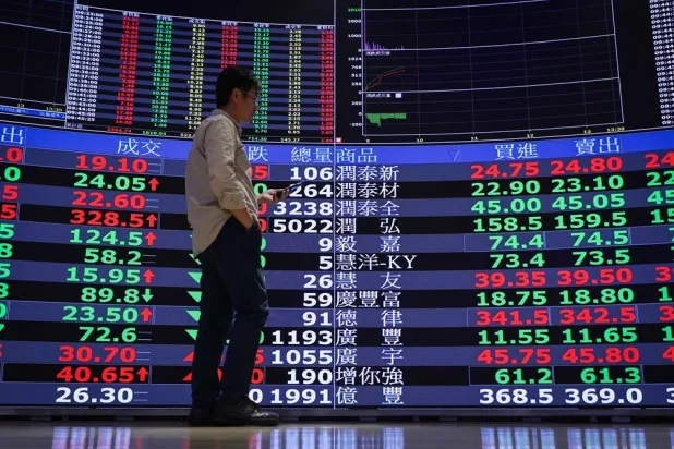 A person looks at a stock market graph inside the Taiwan Stock Exchange in Taipei, Taiwan, 20 April 2026. (EPA)