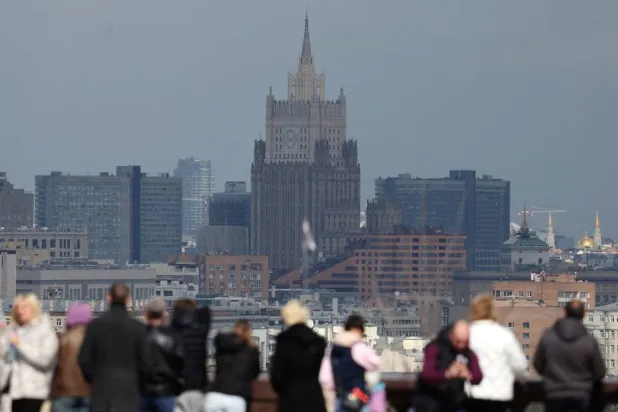 People visit the observation deck at Vorobyovy gory (Sparrow Hills) with the main building of the Ministry of Foreign Affairs of Russia in the background during a spring day in Moscow, Russia, 17 April 2026. (EPA)