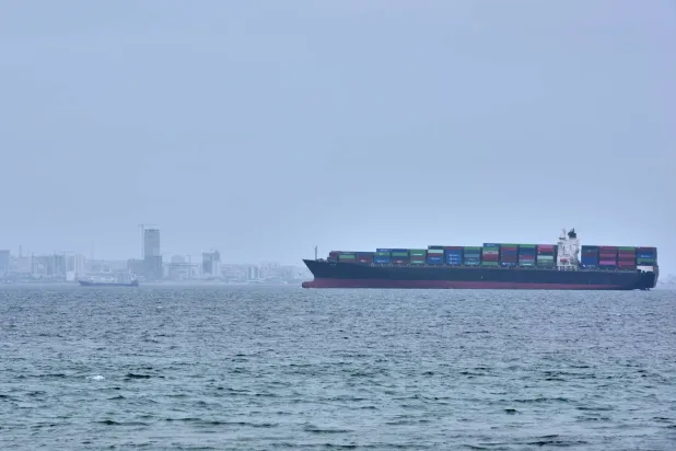 A container ship is seen in the Strait of Hormuz off the coast of Qeshm Island, Iran, Saturday, April 18, 2026. (AP Photo/Asghar Besharati)
