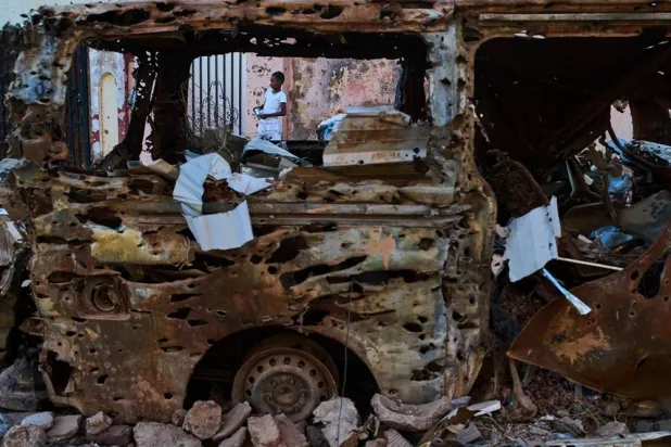  A boy is seen through the wreckage of a car in Omdurman, Sudan, on the outskirts of Khartoum, Friday, April 17, 2026. (AP) 