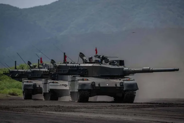 Japan Ground Self-Defense Force (JGSDF) battle tanks take part in a live fire exercise at East Fuji Maneuver Area in Gotemba on May 27, 2023. (AFP) 