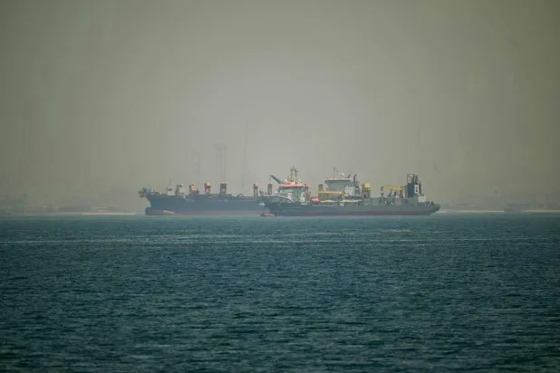 Commercial vessels are seen off the coast of Dubai on April 20, 2026. (AFP)
