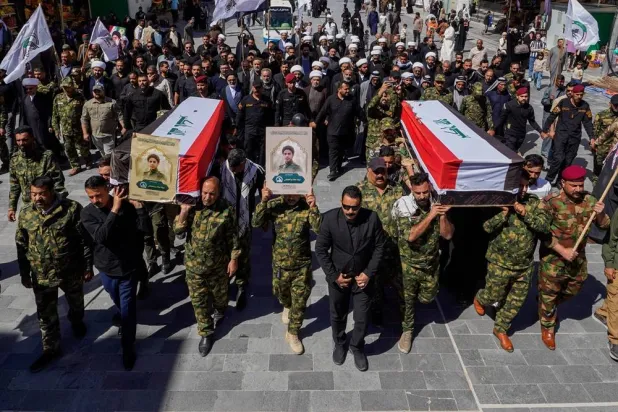 Members of the Popular Mobilization Forces attend a funeral for colleagues who were killed in a US airstrike in Anbar, in Najaf, Iraq, Wednesday, April 1, 2026. (AP) 