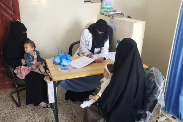 طفلتان برفقة والدتيهما تتلقيان خدمات علاجية أممية لمنع وعلاج سوء التغذية بين الأطفال (الأمم المتحدة)