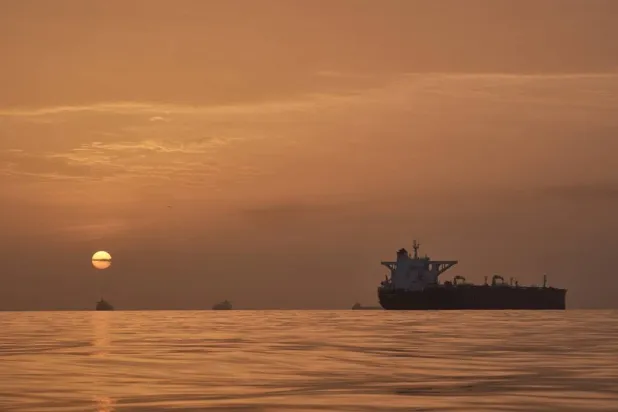  The sun rises behind tankers anchored in the Strait of Hormuz off the coast of Qeshm Island, Iran, Saturday, April 18, 2026. (AP) 