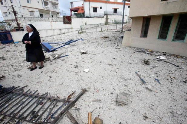A nun inspects a Christian religious site hit by an Israeli strike in the southern Lebanese city of Nabatieh. (AFP)