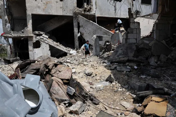 A young boy walks amid the rubble of a building destroyed in an Israeli strike in the southern Lebanese village of Kfar Sir on April 21, 2026. (Photo by Anwar AMRO / AFP)