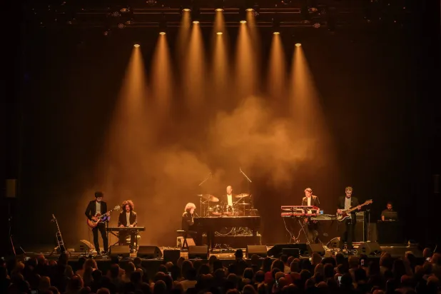 Italian and French singer and songwriter Riccardo Cocciante (C), also known as Richard Cocciante performs during a tribute concert entitled “Au cœur de Crans” for the victims of the New Year’s Eve bar fire in Crans-Montana, at the Salle Métropole in Lausanne on April 22, 2026.  (Photo by Fabrice COFFRINI / AFP)