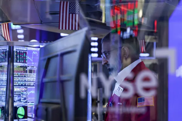A trader works on the floor of the New York Stock Exchange (NYSE) at the opening bell in New York on March 24, 2026.  (Photo by ANGELA WEISS / AFP)