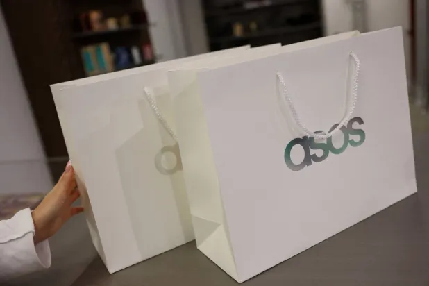 FILE PHOTO: Branded shopping bags are displayed in an ASOS pop-up store in London, Britain, November 12, 2025. REUTERS/Hannah McKay/File Photo