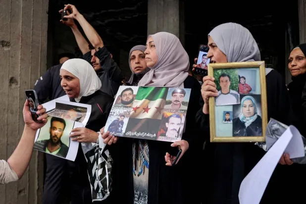 Residents gather in a street after Friday prayers to celebrate the arrest of Amjad Yousef, a key suspect in the 2013 Tadamon massacre, in Tadamon, Syria, April 24, 2026. (Reuters)