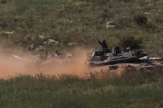 Israeli tanks drive in Lebanon, as seen from the Israeli side of the Israel-Lebanon border, in northern Israel, April 25, 2026. (Reuters)